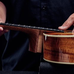 Image of a Taylor Action Control Neck being set into an acoustic guitar body